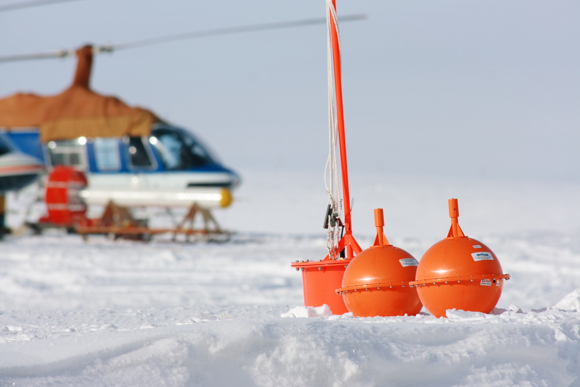 Sea-ice buoy expedition with helicopter in background