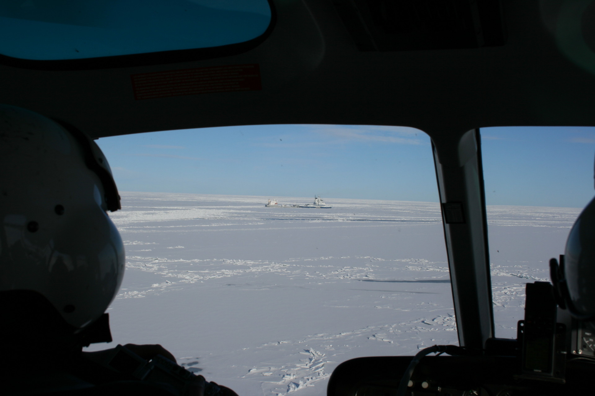 View of icebreakers in ice from helicopter cockpit